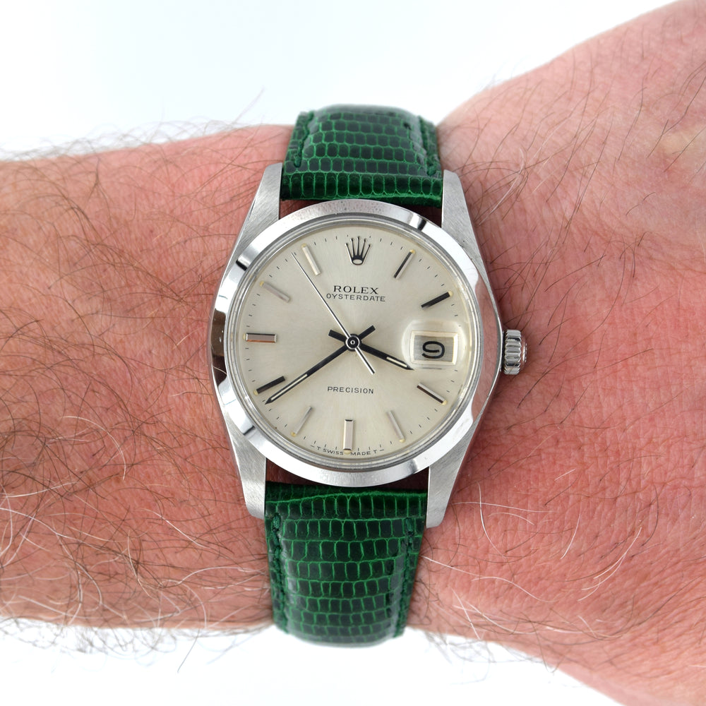 Vintage Rolex watch with green strap on a wrist