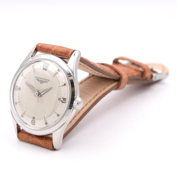Longines watch with brown leather strap on a white background