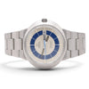 An Omega wrist watch with a stainless steel bracelet, featuring a silver-toned dial, blue concentric ring details, and a blue day indicator, shown on a white background.