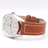 An Omega Seamaster wristwatch with a silver-tone case, white dial, and a brown leather strap with white stitching, shown on a white background.