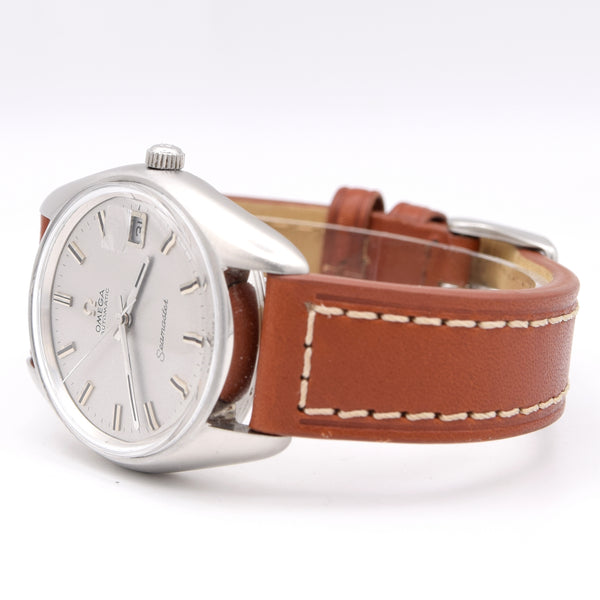 An Omega Seamaster wristwatch with a silver-tone case, white dial, and a brown leather strap with white stitching, shown on a white background.