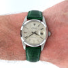 Vintage Rolex watch with green strap on a wrist
