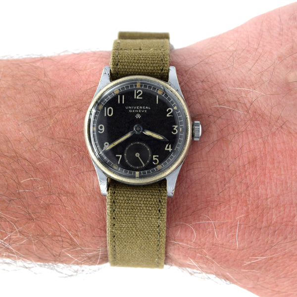 Watch with a green strap on a wrist against a white background