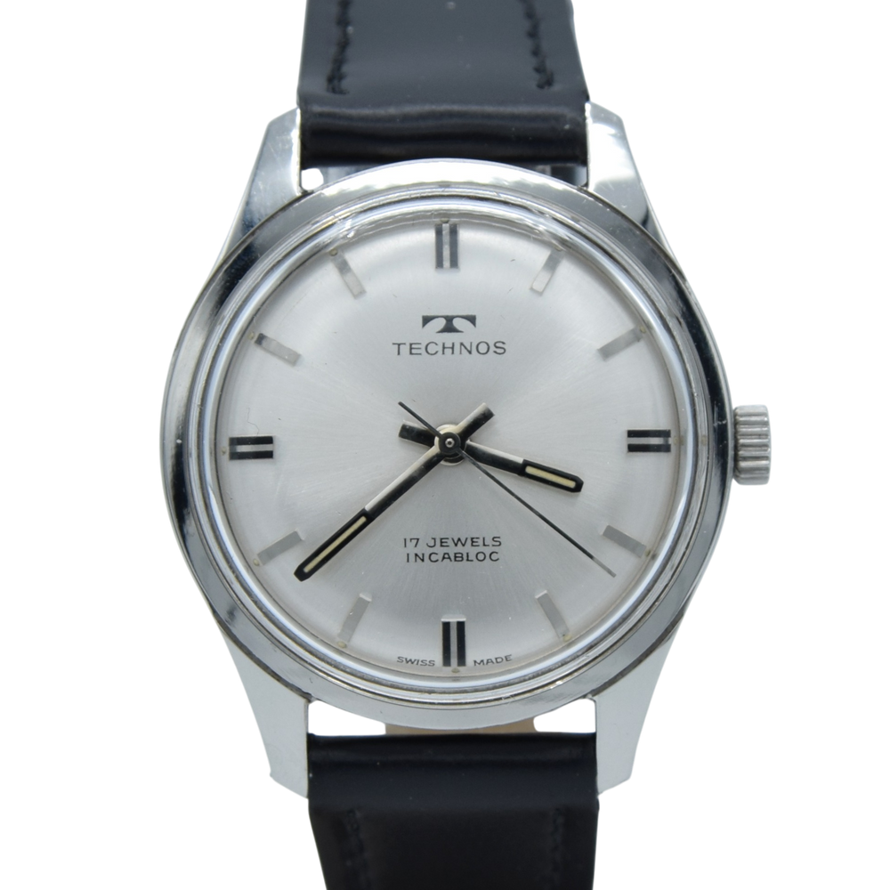 1960s Technos Mid-Size Steel Manual Wind On Leather Strap With Original Signed Buckle – Silver Sunburst Dial