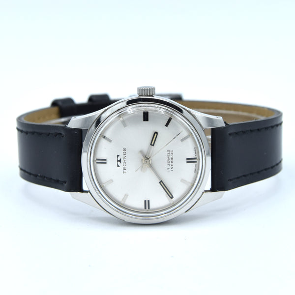 1960s Technos Mid-Size Steel Manual Wind On Leather Strap With Original Signed Buckle – Silver Sunburst Dial