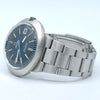 Omega Seaweed stainless steel watch with a blue dial and silver metal bracelet, photographed on a light blue-white background.