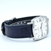 A vintage Omega Quartz wristwatch with a silver-toned rectangular case, white dial, and a dark navy blue leather strap with blue stitching, shown on a white background.