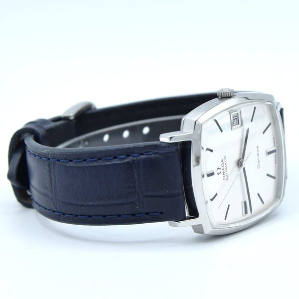 A vintage Omega Quartz wristwatch with a silver-toned rectangular case, white dial, and a dark navy blue leather strap with blue stitching, shown on a white background.
