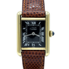 A Cartier Tank watch with a gold-tone rectangular case, black dial with white Roman numerals, and a brown textured leather strap, shown on a plain white background.