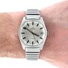 An Omega Automatic wristwatch with a silver-tone stainless steel case and integrated link bracelet, shown worn on a person's wrist against a white background.